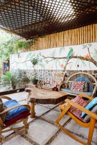 サン・マルコス・ラ・ラグナにあるCasa Mike, San Marcos La Lagunaの椅子とテーブル、壁に鳥が置かれた部屋