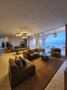 a living room with couches and a pool table at Villa La Falaise in Oualidia