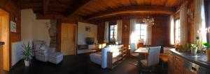 a living room with a couch and a table at Ferienwohnung Sonnenleithe Urlaub im Denkmal in Breitenbrunn