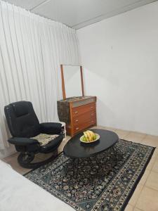 a living room with a chair and a coffee table at Skyview Retreat Romantic Retreat Views 360 Rooftop in Tel Aviv