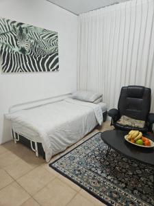 a bedroom with a bed and a table and a chair at Skyview Retreat Romantic Retreat Views 360 Rooftop in Tel Aviv