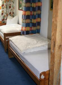 two twin beds in a room with a curtain at Herrenhof in Worms +61 photos