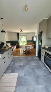 a kitchen and living room with a table in it at Parenthèse en Terre Breizh in Bohal +16 photos