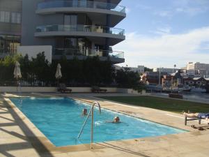 two people in a swimming pool in a building at 202 Kylemore A Waterfront Marina in Cape Town