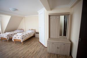 a bedroom with two beds and a large mirror at Mestiatour Guest House in Mestia