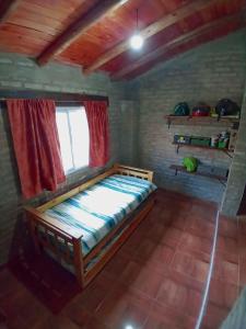 a bedroom with a bed in a room with a window at Casa en Rumipal de 4 a 11 personas in Villa Rumipal