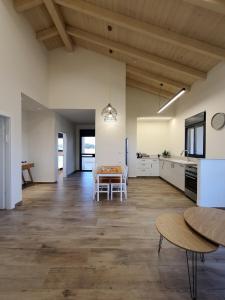an open kitchen and dining room with a table at hod barama- ישוב שומר שבת צ'ק אין לפני שבת צ'ק אאוט במוצש in Haspin +13 photos