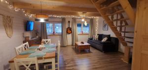 a dining room and living room with a table at FreeDom House in Dolina