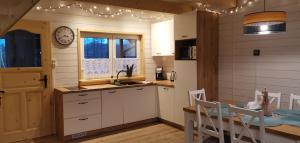 a kitchen and dining room with a table and a dining room at FreeDom House in Dolina