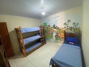 a room with two bunk beds and a mural at Casa Colorida in Prado