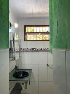 a bathroom with a sink and a window at Casa Colorida in Prado