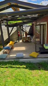 a patio with pillows and a table under a roof at Cabañas El Ermitaño in Puerto Montt