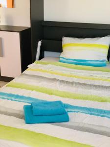 a bed with two towels sitting on top of it at SEEnsation in Uhldingen-Mühlhofen