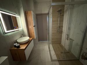 a bathroom with a shower and a sink and a toilet at Dubai Marina Guest House in Skopje +92 photos