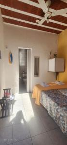 a bedroom with a bed and a ceiling fan at Pousada Casa de Buzios in Búzios +57 photos