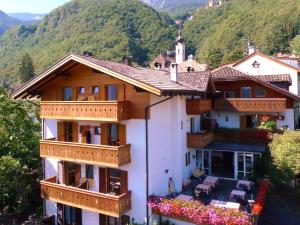 a large white building with balconies and a mountain at Pension Stamserhof in Nalles