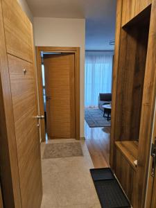 a hallway with a door and a room at Zlatibor Centar Lux in Zlatibor +23 photos