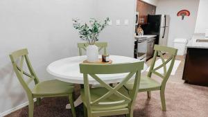 a kitchen with a table and chairs with a vase of flowers at Spacious Family Value Retreat with Pool & Garage in Corpus Christi