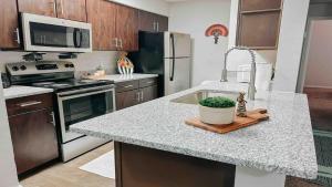 a kitchen with a counter with a sink and a stove at Spacious Family Value Retreat with Pool & Garage in Corpus Christi