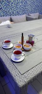 a table with bowls and cups of tea on it at Olimpia Hotel&Spa in Odesa