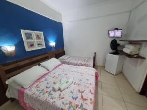 Postel nebo postele na pokoji v ubytování Pousada Brilho De Paraty