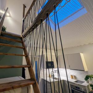 a staircase in a room with a window at Bordeaux Autrement - Une escapade dans la Canopée in Cenon