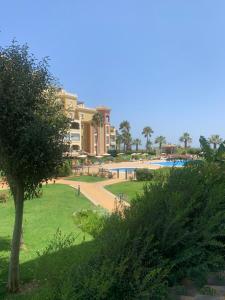 a view of a resort with a park and a pool at Canela Garden in Isla Canela