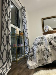 a bedroom with a bed and a window at Hertford farm Woodland cabin pet friendly firepit bbq in Hertford