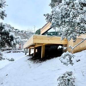 a house covered in snow in a yard at Corrales de la Aldea Alojamiento Paisajístico in Pontones