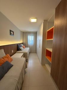 a hotel room with two beds and a couch at Apartamento Iberostate Praia do Forte, 2 quartos in Mata de Sao Joao +23 photos