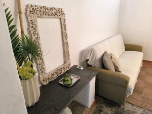 a living room with a mirror and a couch at Sublime Village House in Monsaraz
