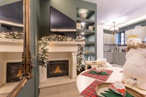 a living room with a fireplace and christmas decorations at Rock Dandy La Maison De L'Ours - Unique Mountain Escape in Nymfaio