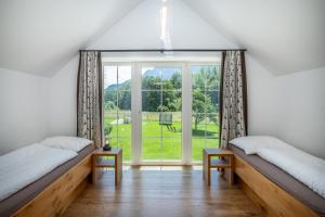 Postel nebo postele na pokoji v ubytování Naturresort FiSCHERGUT - Lodge Wolfgangthal