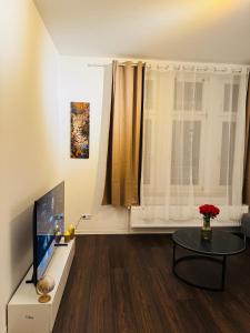 a living room with a television and a table at Charmante Auszeit im Harz in Blankenburg
