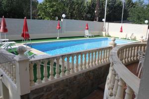 a swimming pool with a white railing and a swimming pool at Hotel Las Nieves in Las Nieves