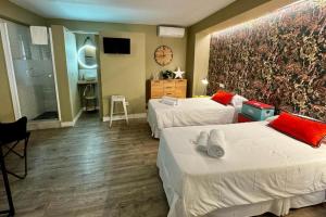 a hotel room with two beds and a bathroom at TAK Boutique Old Town Marbella in Marbella
