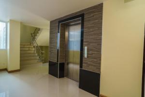 a hallway with a elevator in a house at Sritrang Place in Hat Yai