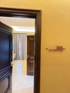 a door to a room with a sign on the wall at Sol Luxury Suites in Kumasi