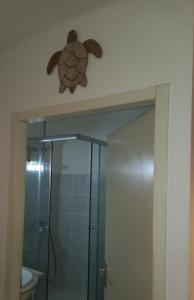 a bathroom with a shower with a turtle on the wall at Lagoon Studio Plage in Schœlcher +14 photos
