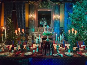 a dining room with a table with christmas decorations at Le Château des Rêves de la Ferté Fresnel in La Ferté-Frênel