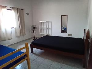 Ένα ή περισσότερα κρεβάτια σε δωμάτιο στο Sobrado no litoral norte de são Sebastião