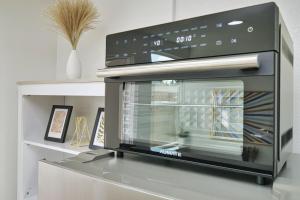 a microwave oven sitting on top of a stove at Molivu Homes 1BR - New Build, Pet Friendly, W-D in San Jose