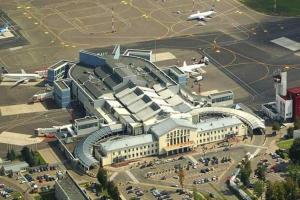 a large building with an airport with a plane at freeparking apartment in Vilnius