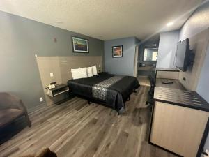 a bedroom with a bed and a television in it at Orange Tustin Inn in Orange in Orange