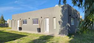 a white building with doors on the side of it at Airemar 2 in Playa Dorada