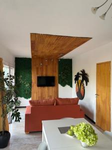 a living room with a red couch and a table at Casa del Árbol in Monte Hermoso