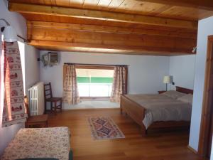 a bedroom with a bed and a window at Tana Della Volpe in Sestriere