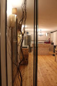 a glass door with a sculpture of a tree at Rooms Maison 3 Magnoni in Trieste