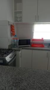 a kitchen with a stove and a counter top at Departamento de playa in Asia