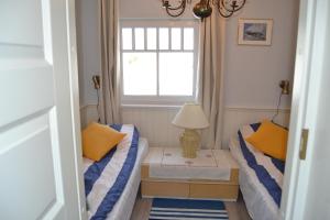 a small room with two beds and a window at Taimela Holiday Home with Sauna in Lohusalu +30 photos